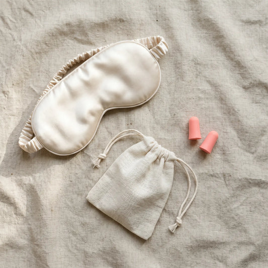 Flat lay of DriftKit travel sleep essentials for long flights
