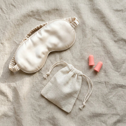 Flat lay of DriftKit travel sleep essentials for long flights